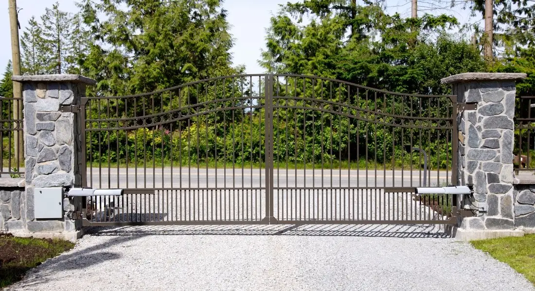 automatic wrought iron gate with stone pillars