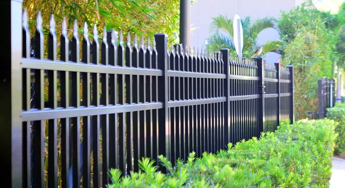 black metal security fence with pointed tops