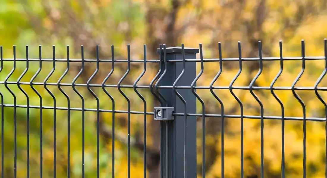 close up of modern metal fence panel with support post