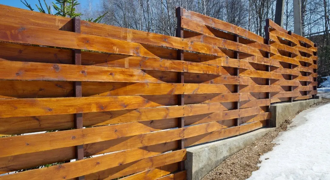 modern horizontal wooden fence with staggered design