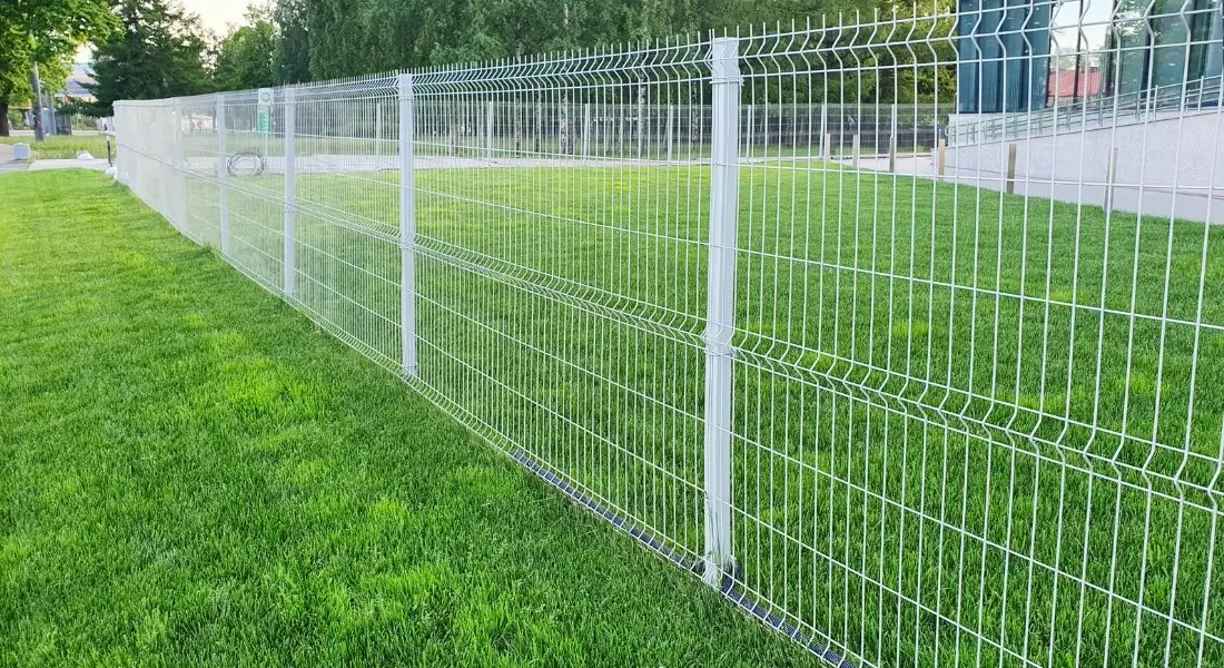 white metal mesh fence surrounding green lawn