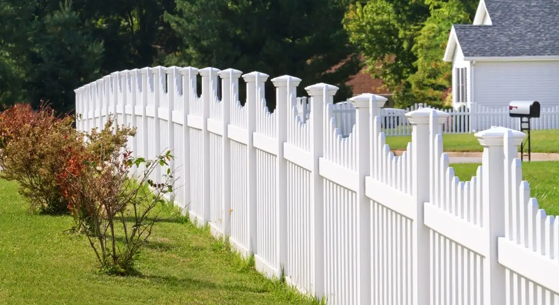 white vinyl fence around a suburban home